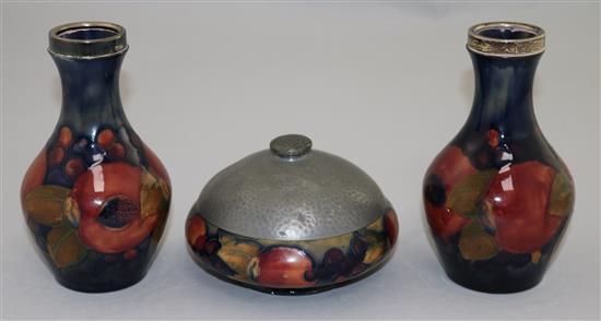 A pair of William Moorcroft Pomegranate pattern small vases, vases 14cm, bowl 20cm diameter